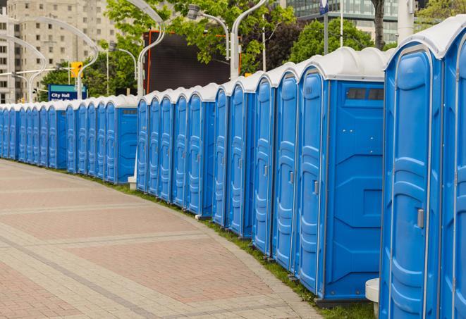 a row of portable restrooms at an outdoor special event, ready for use in Berkley MI